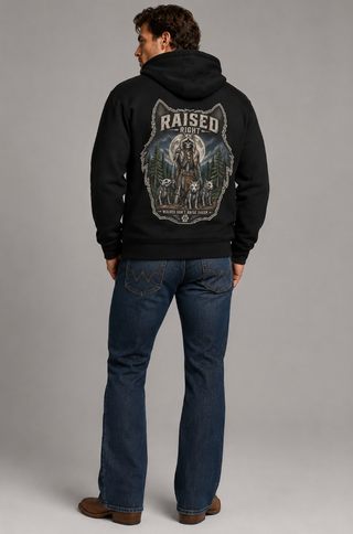 Man wearing a black hoodie with a graphic design on the back against a gray background